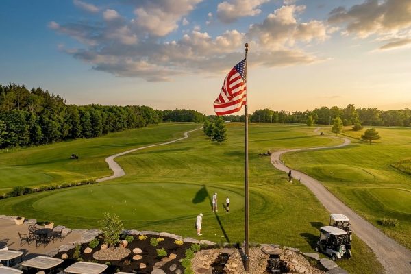 American flag overlooking putting green and clubhouse at Ironwood Golf Course in Western New York